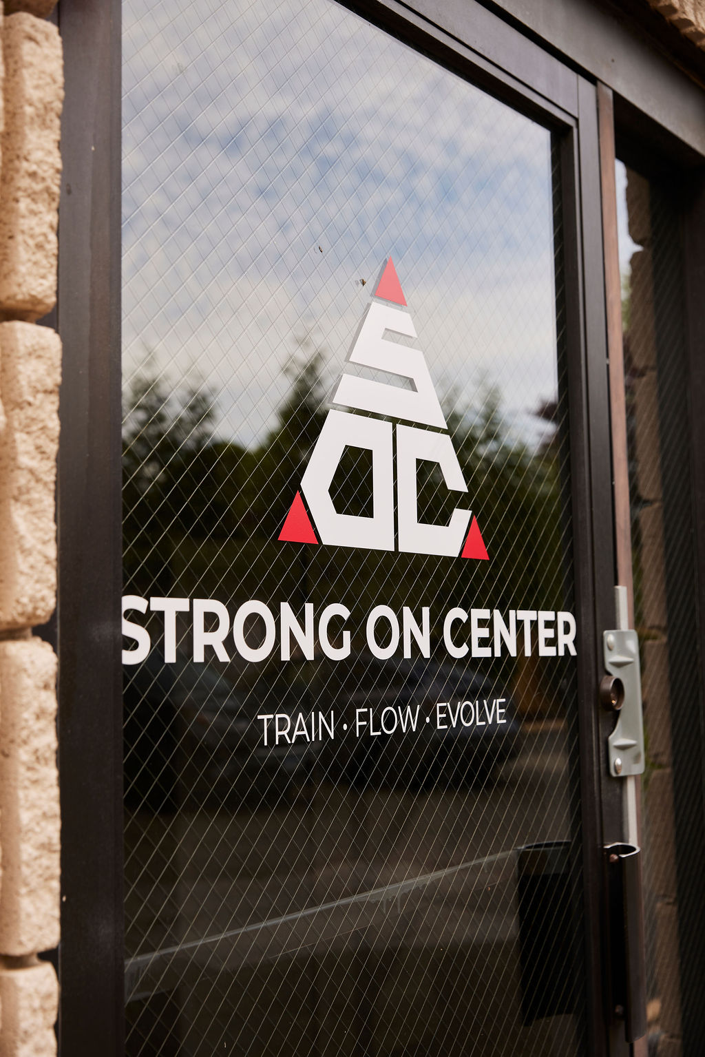 The Strong on Center studio entrance with the SOC logo on the front door.